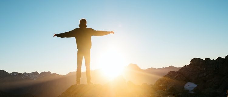 man on hill in sun