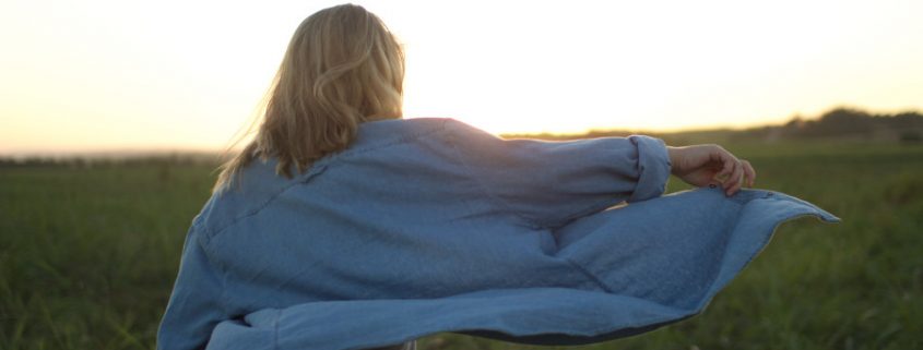 woman approaching sunrise